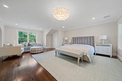 a front view of a house with a yard and trees