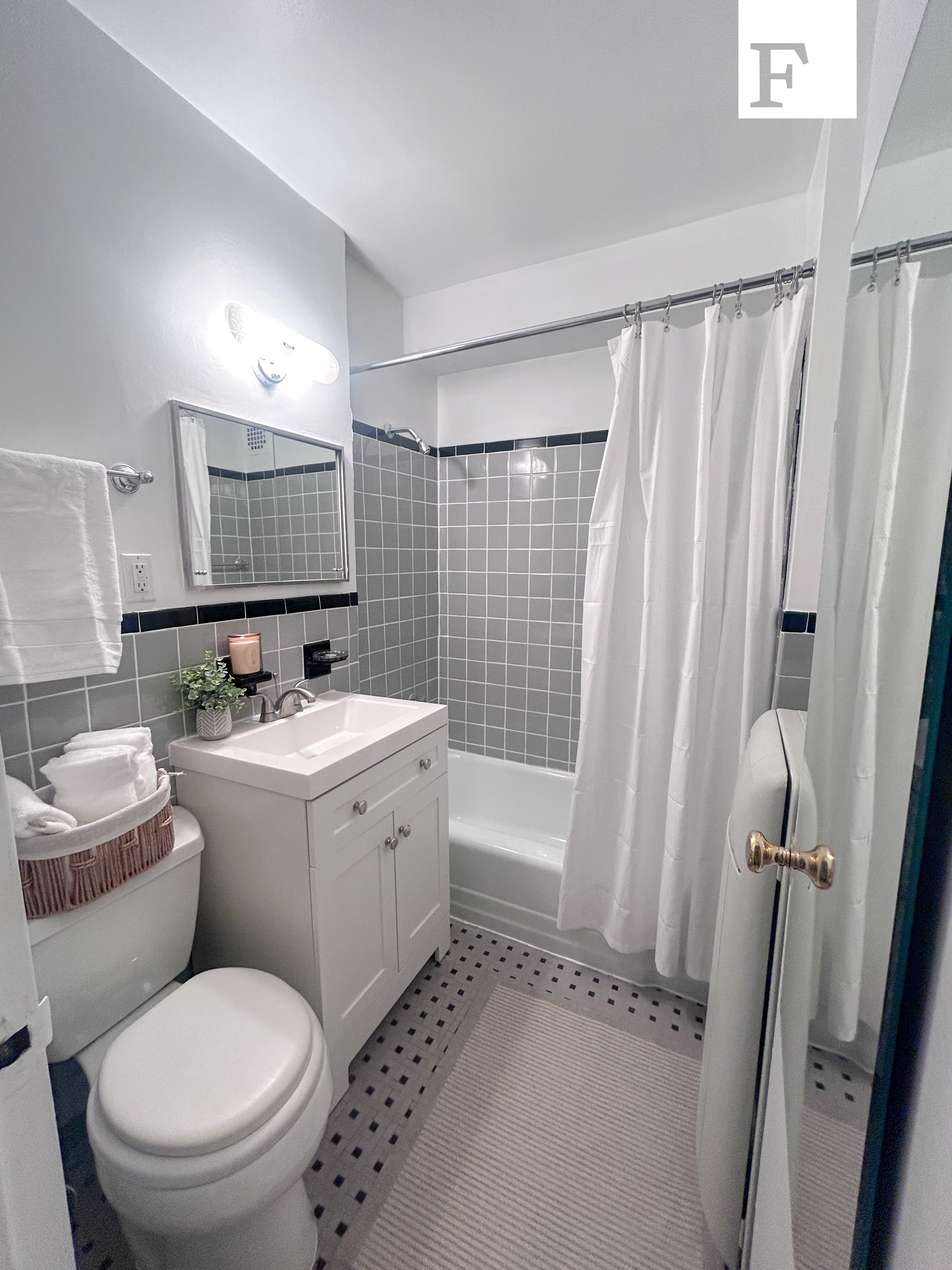 25 West 13th Street, Unit 6KS Manhattan, NY 10011 - Photo 6 of 8 a bathroom with a sink toilet and shower