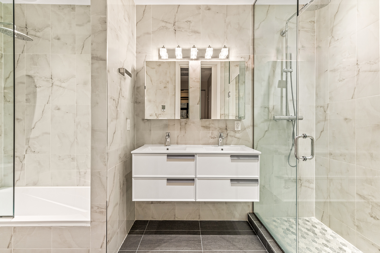 128 West 26th Street, Unit 10 Manhattan, NY 10001 - Photo 9 of 15 a bathroom with a double vanity sink mirror and shower