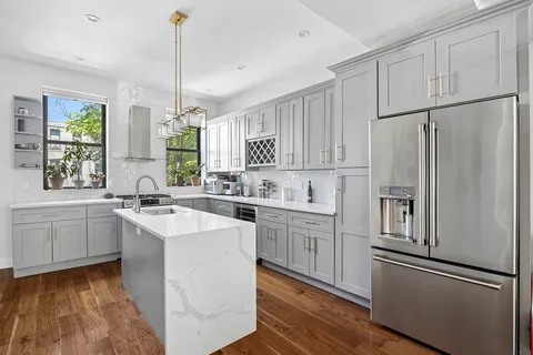 a kitchen with white cabinets and white appliances