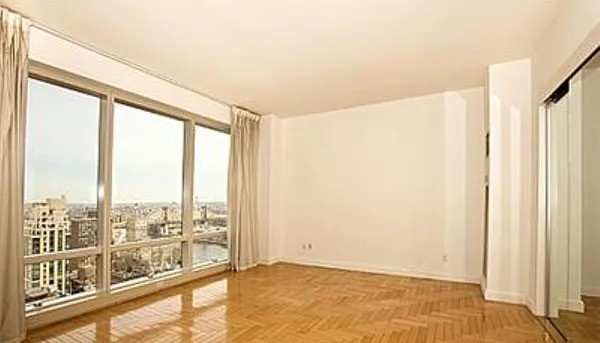 845 United Nations Plaza, Unit 56E Manhattan, NY 10017 - Photo 2 of 28 a view of an empty room and window