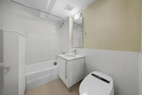 a bathroom with a sink a toilet and bathtub