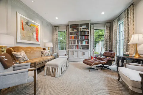 a living room with furniture and large windows