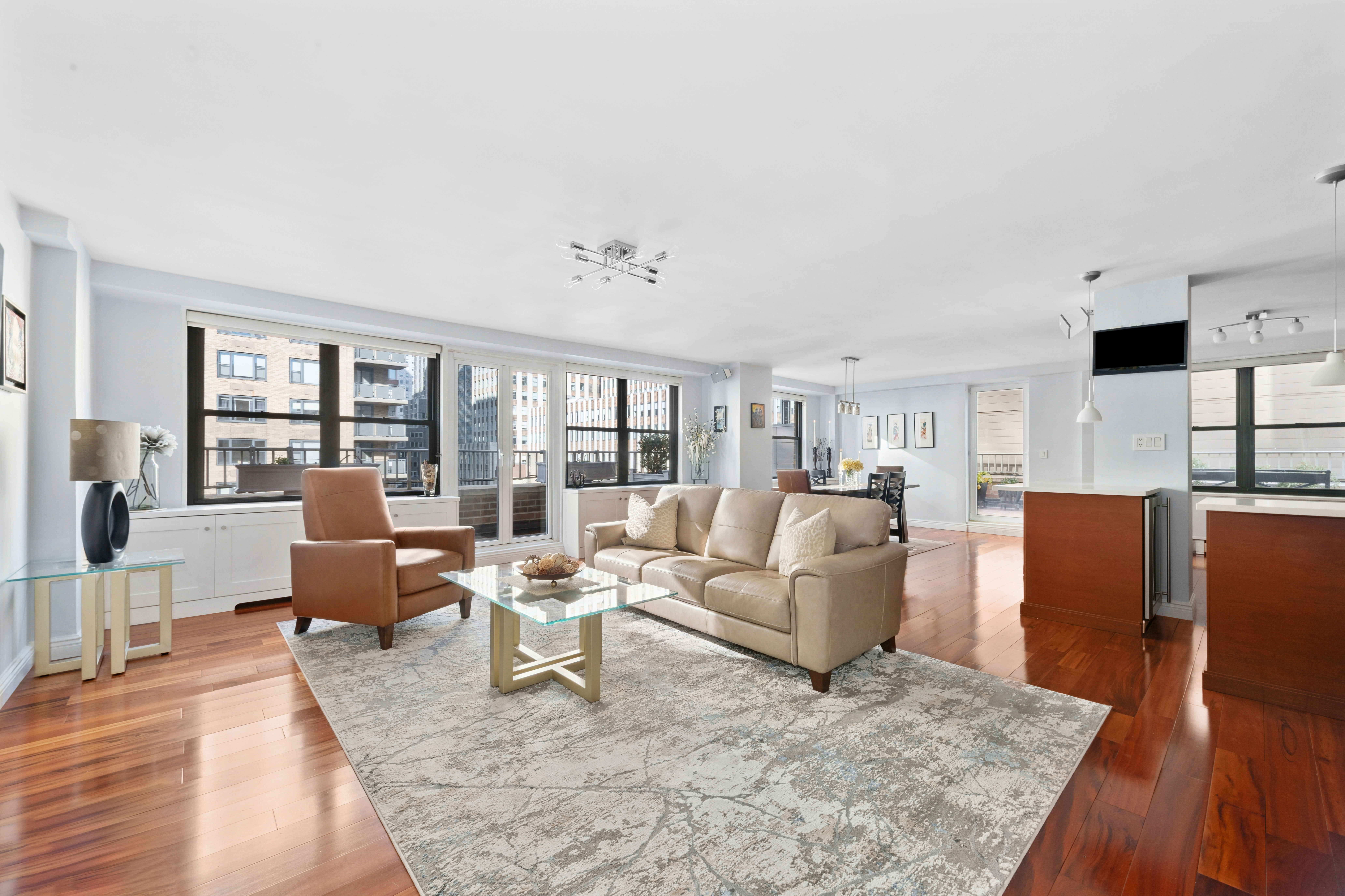 305 East 40th Street, Unit 19CD Manhattan, NY 10016 - Photo 1 of 16 a living room with fireplace furniture and a wooden floor