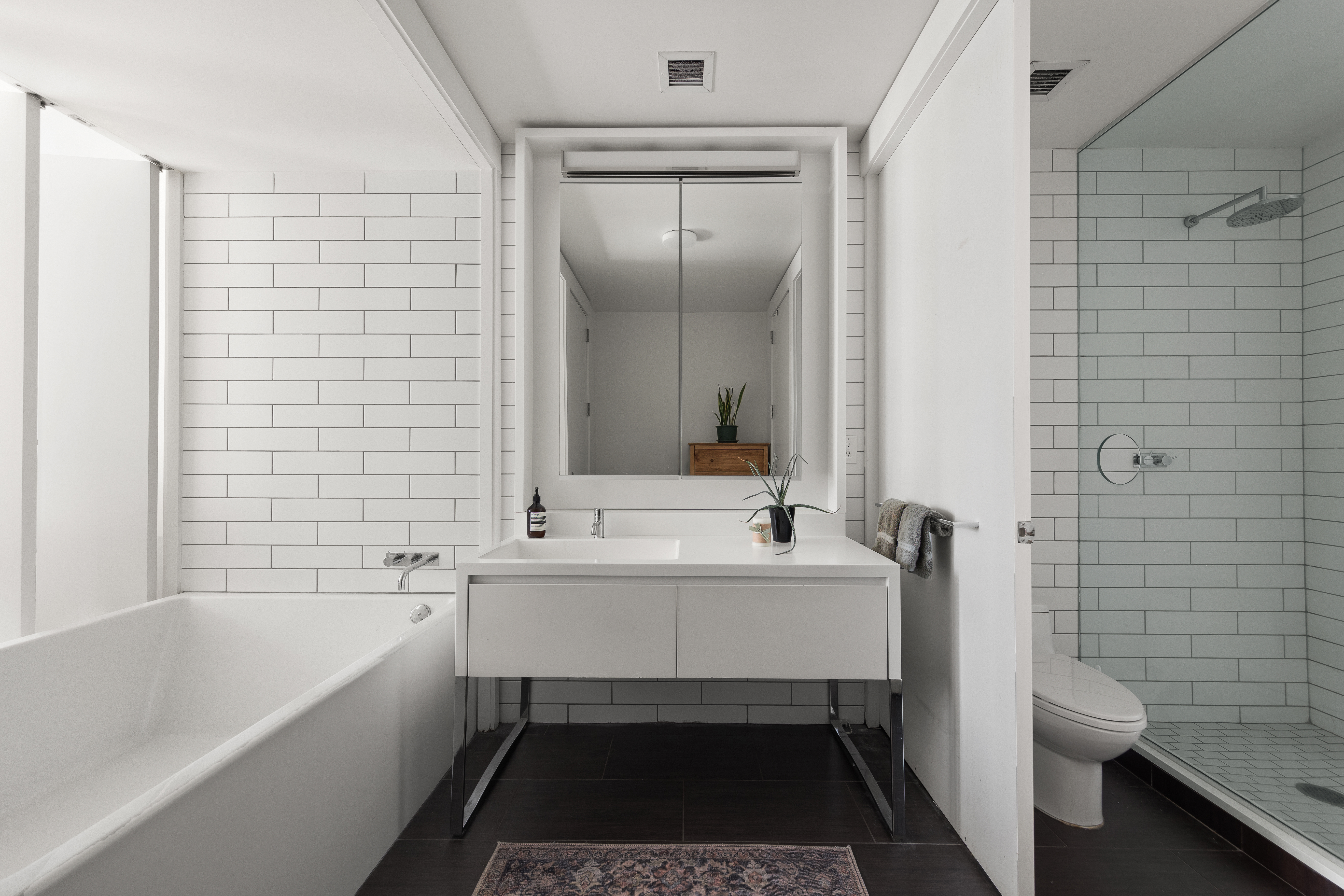 15 William Street, Unit 10C Manhattan, NY 10005 - Photo 8 of 15 a bathroom with a sink a toilet and shower