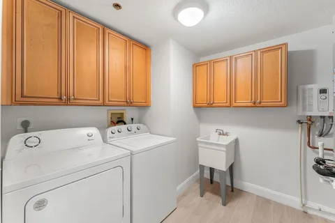 a view of storage and utility room with washer and dryer