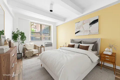 a bedroom with a bed and a painting on the wall