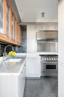 a kitchen with a stove a sink and a refrigerator