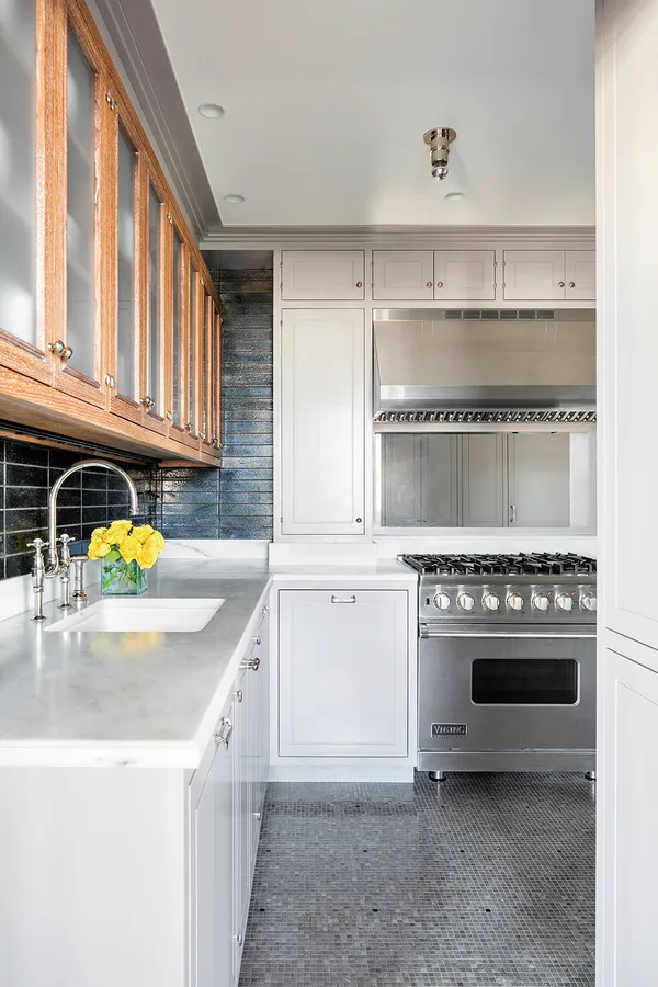 a kitchen with a stove a sink and a refrigerator