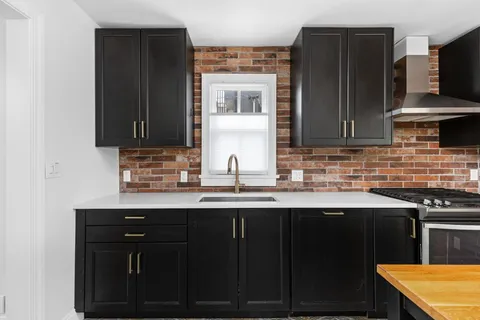 a kitchen with stainless steel appliances a sink stove and refrigerator