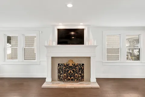 a living room with a fireplace and a flat screen tv