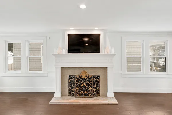 a living room with a fireplace and a flat screen tv