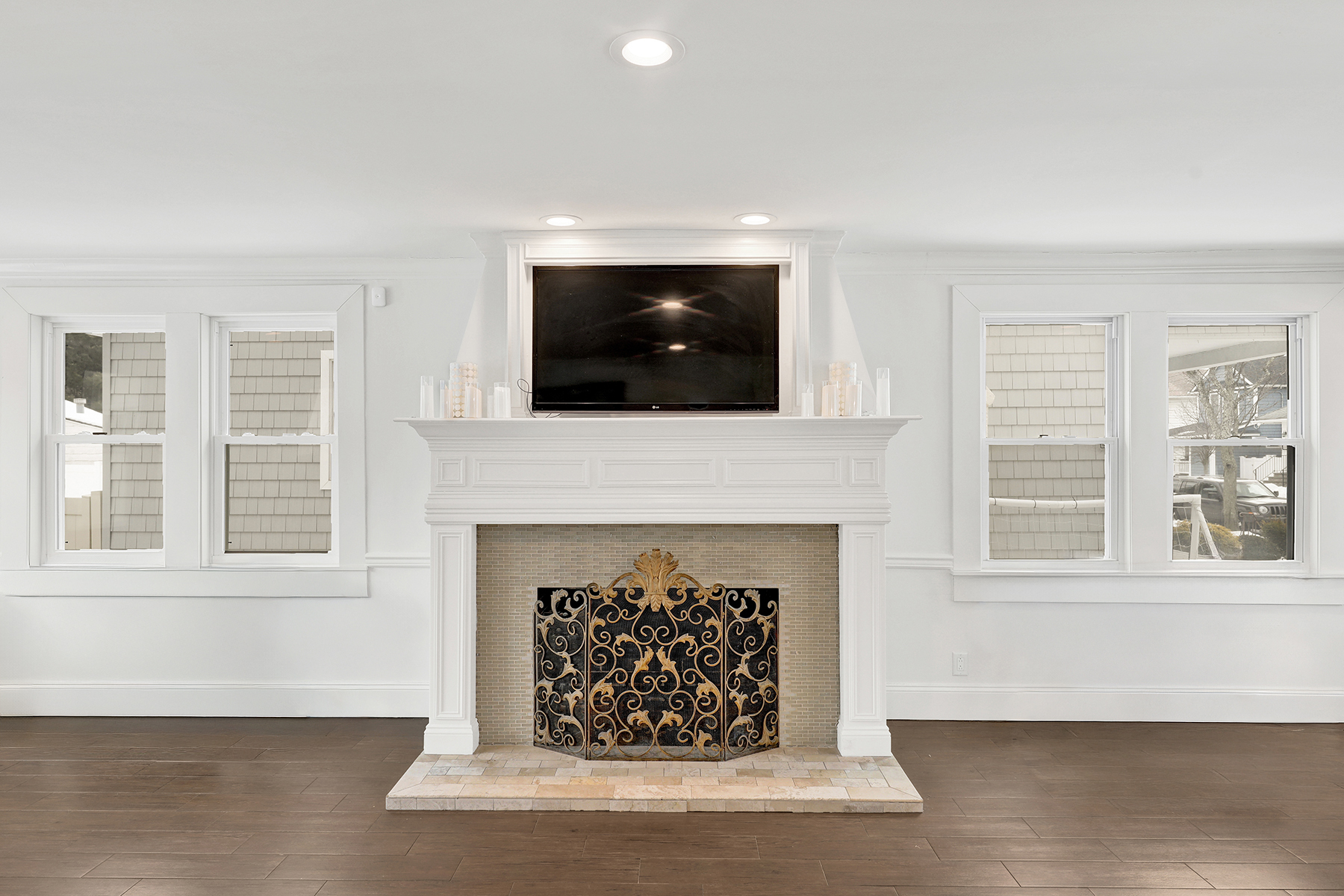 334 Beach 146th Street Queens, NY 11694 - Photo 7 of 21 a living room with a fireplace and a flat screen tv