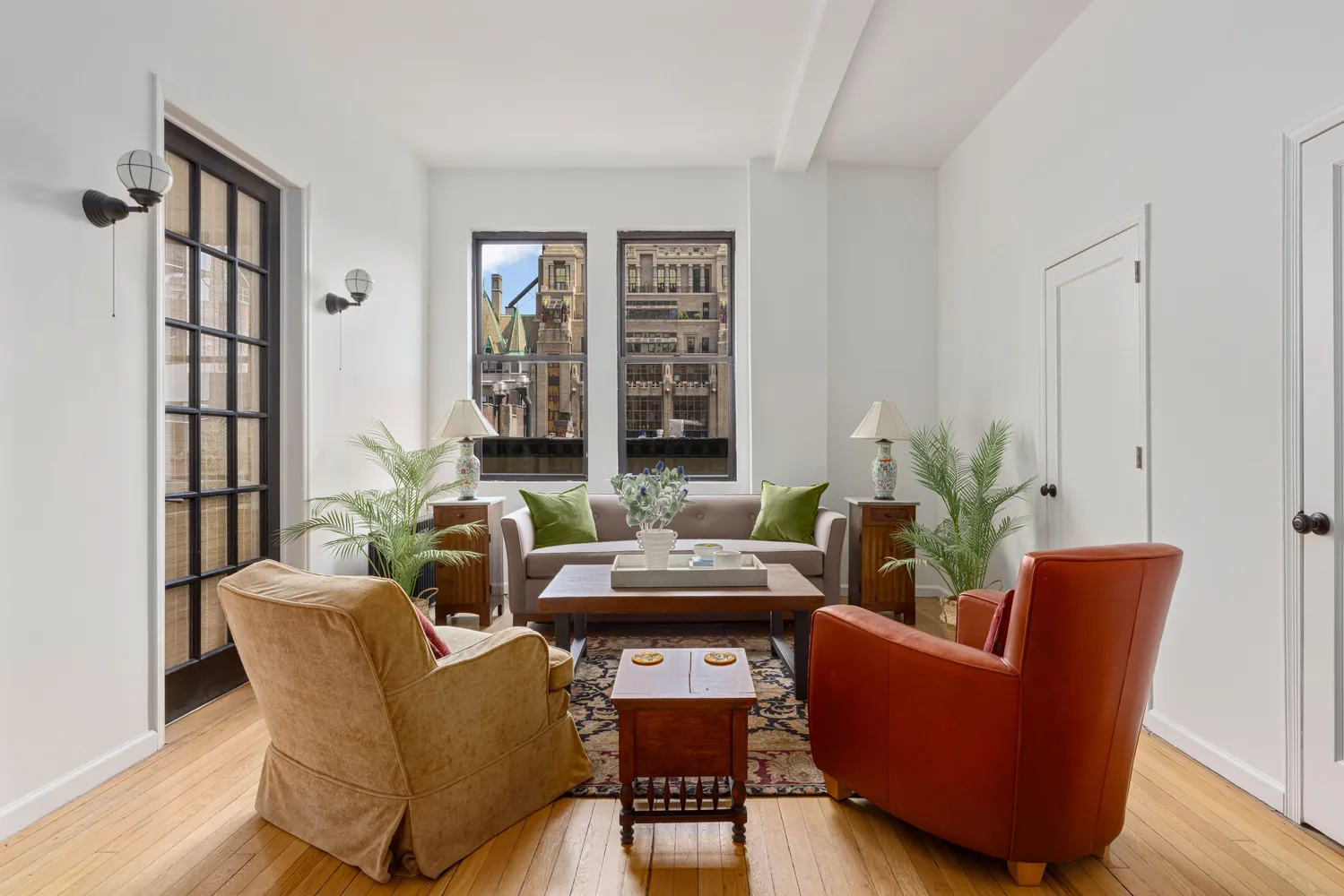 a living room with furniture and a potted plant