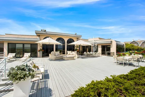 a view of a house with sitting area and garden