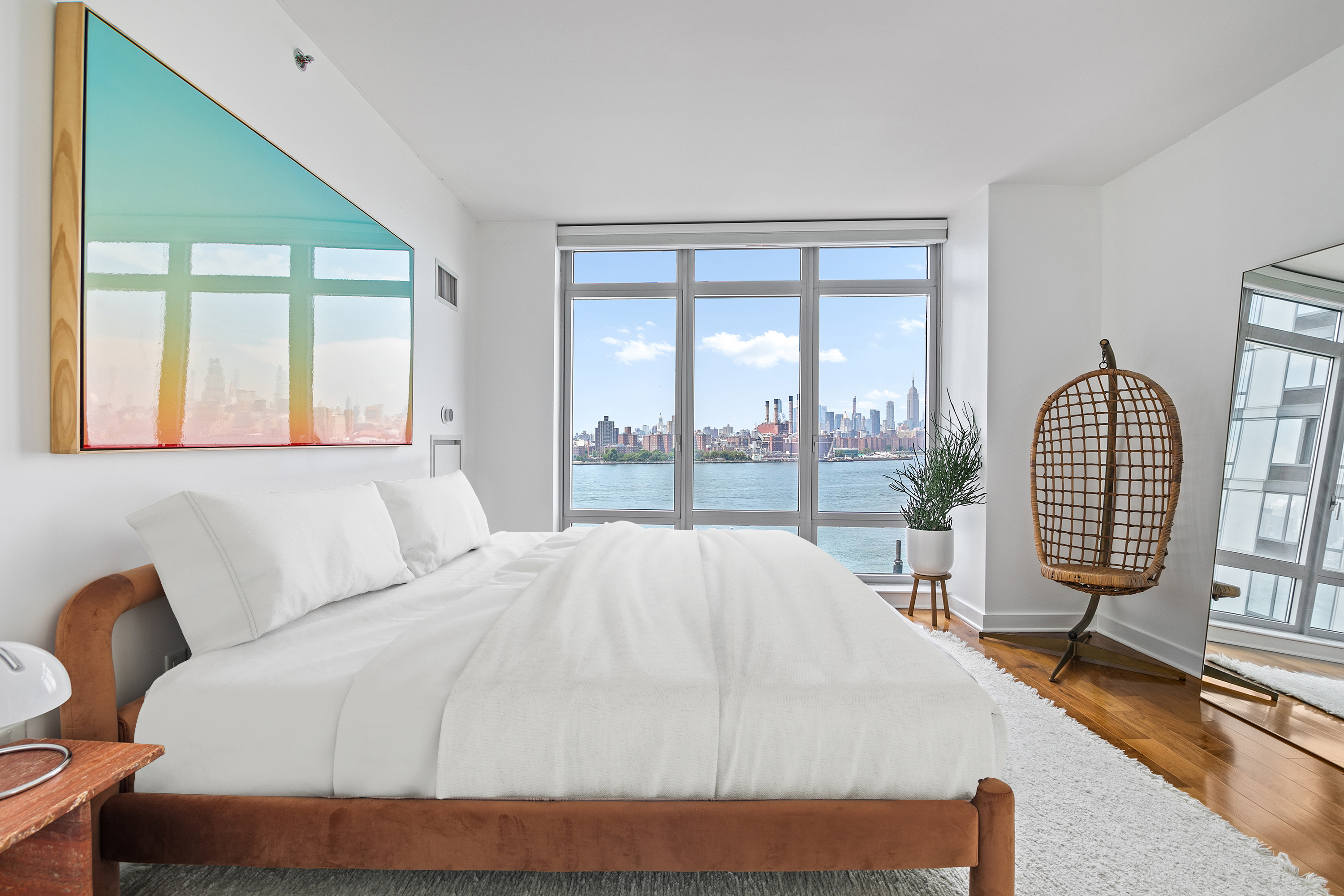 2 Northside Piers, Unit 17A Brooklyn, NY 11249 - Photo 9 of 21 a bed sitting in a bedroom next to a window