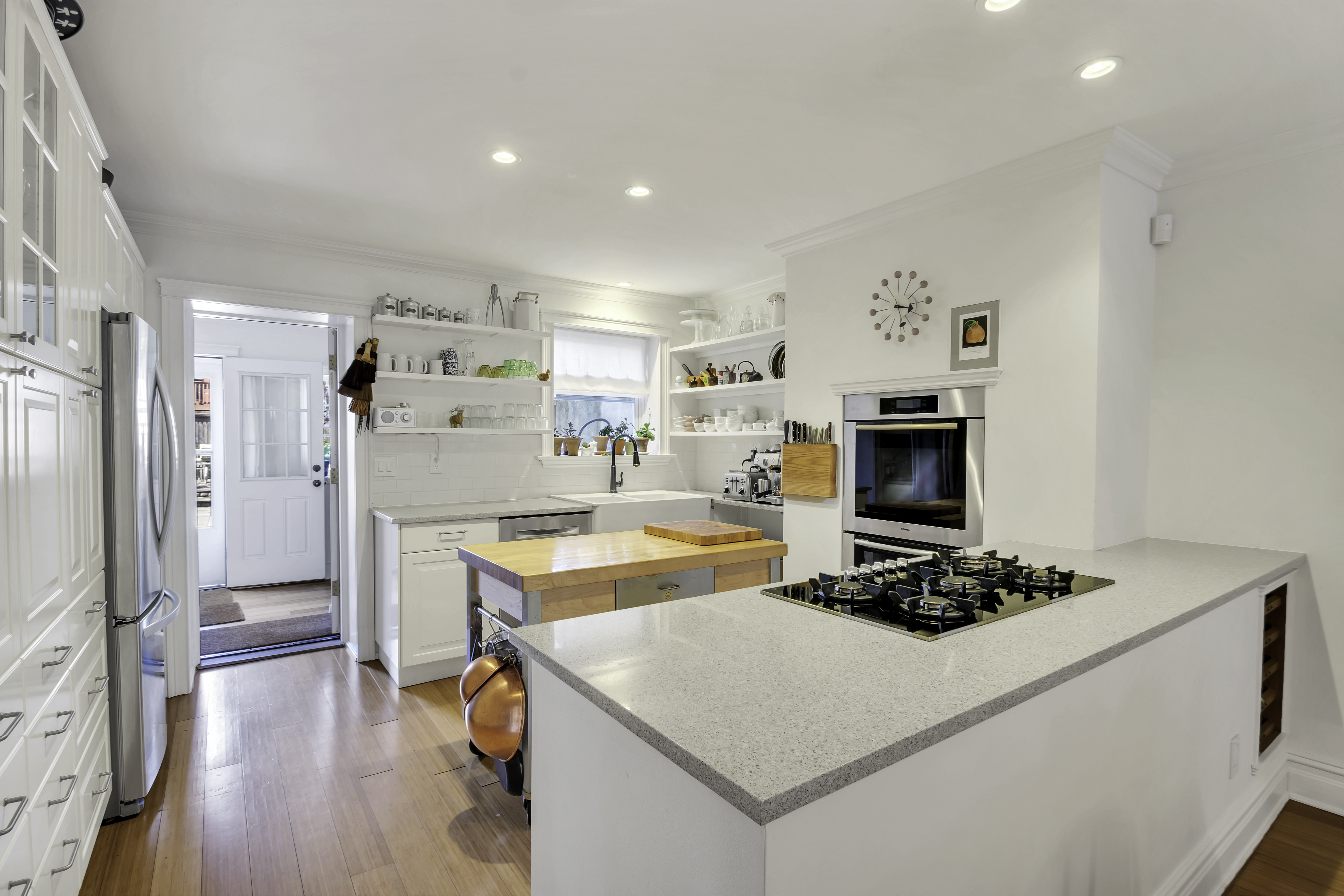 713 Greene Avenue, Unit GARDEN Brooklyn, NY 11221 - Photo 4 of 13 a room with a refrigerator a stove and a wooden floor