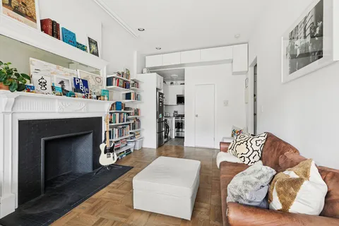 a living room with furniture and a fireplace