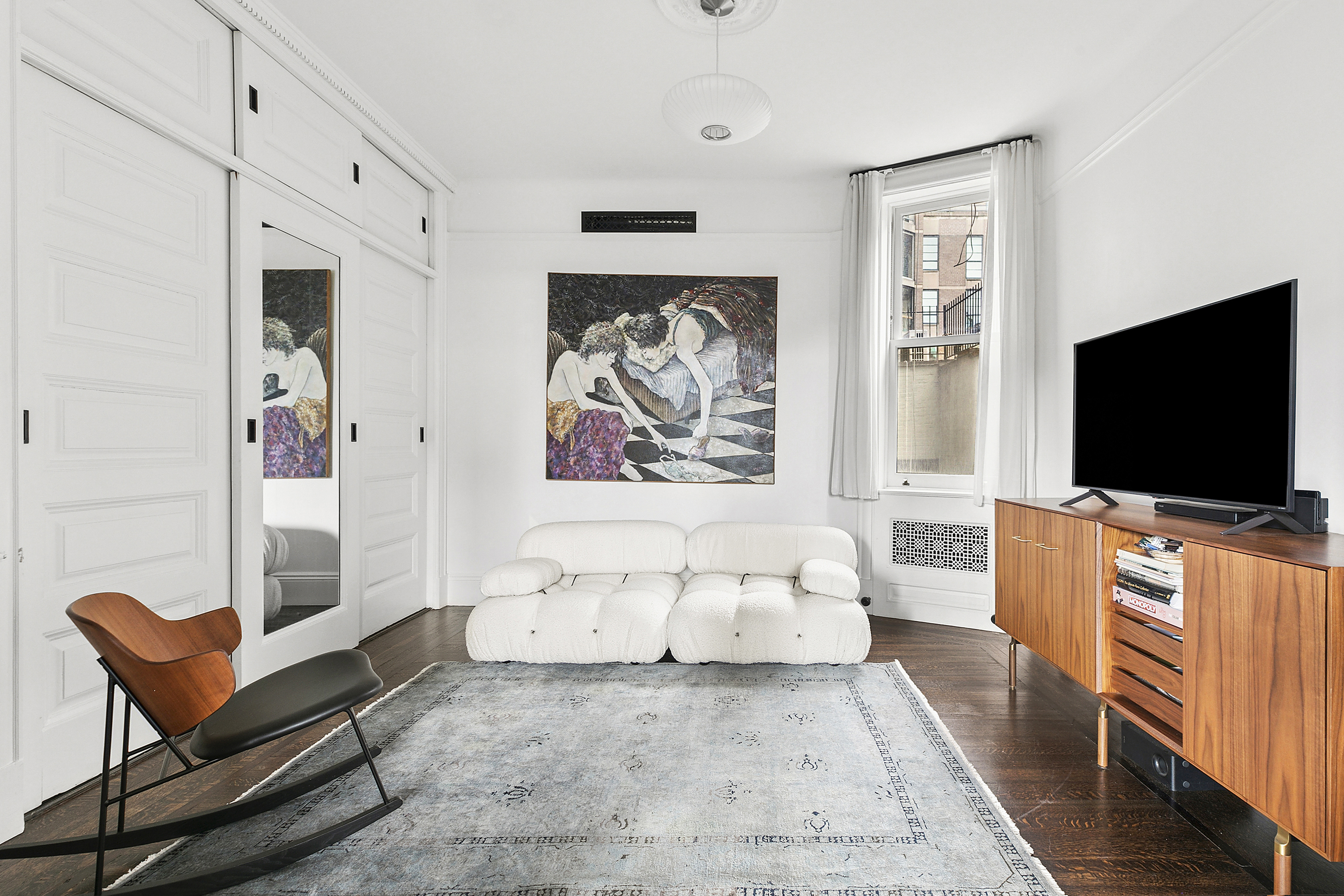 31 West 12th Street, Unit 5E Manhattan, NY 10011 - Photo 7 of 14 a living room with furniture and a flat screen tv