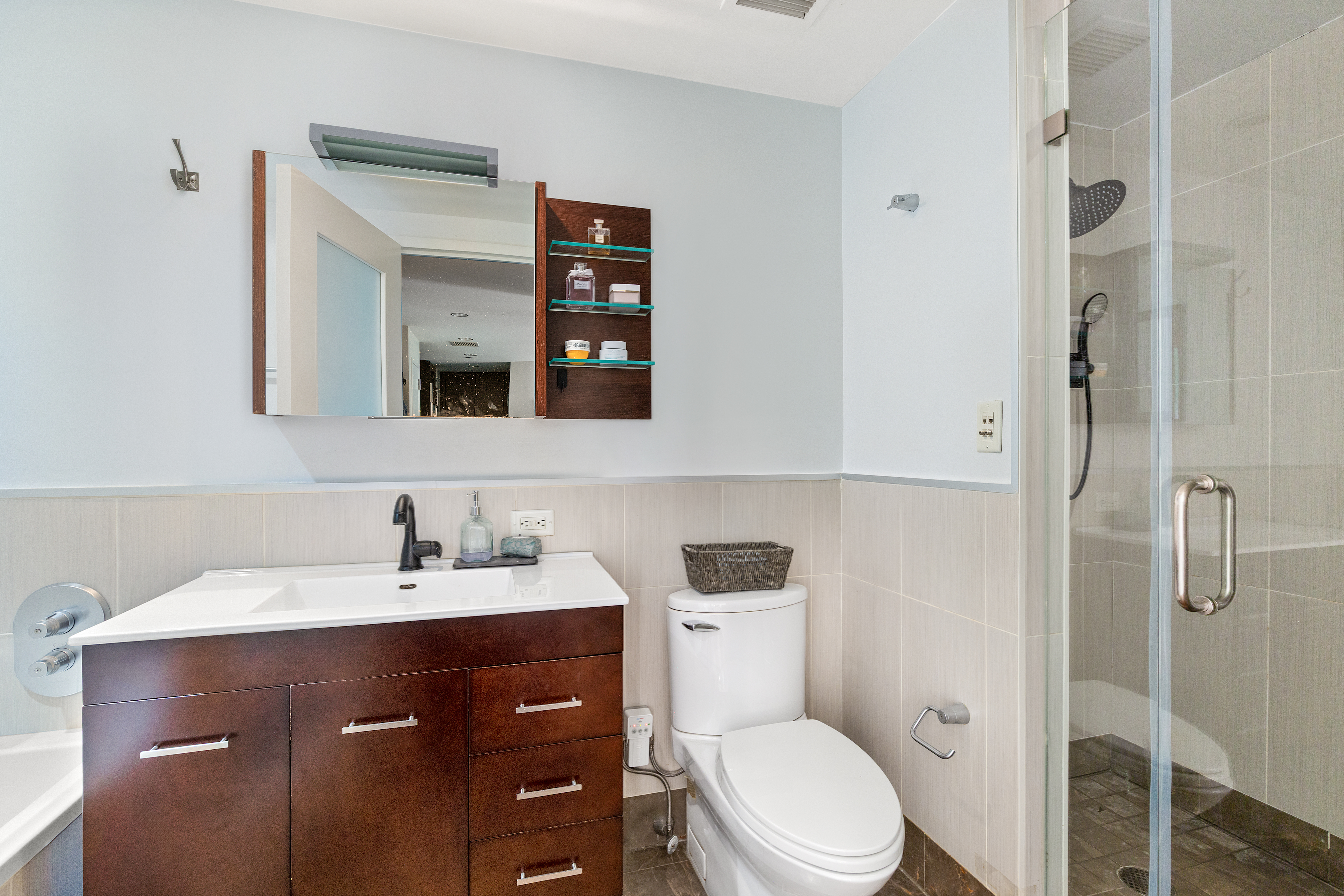 225 East 34th Street, Unit 3K Manhattan, NY 10016 - Photo 7 of 19 a bathroom with a sink vanity mirror and toilet