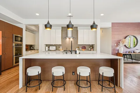 a large kitchen with a table and chairs