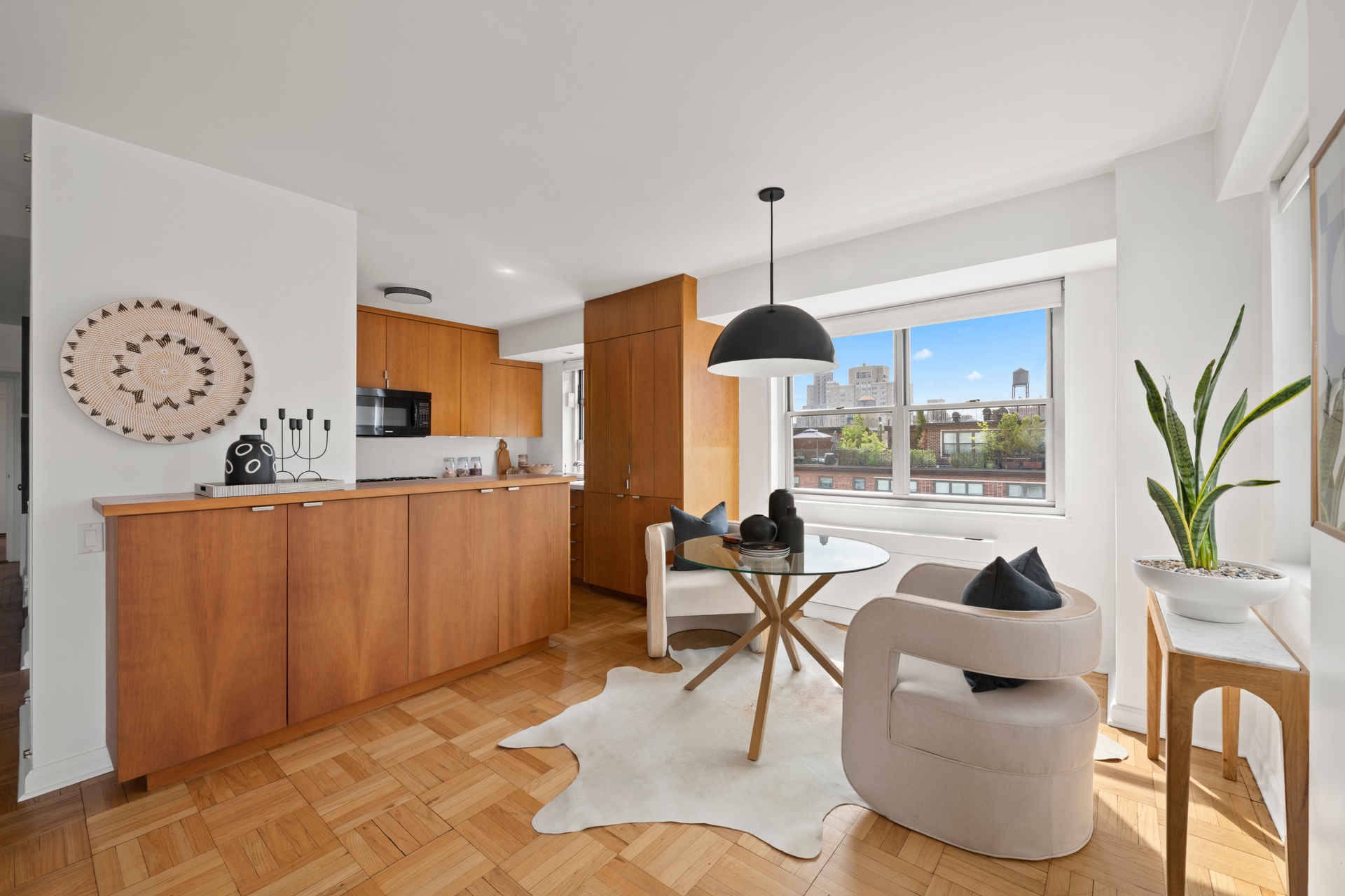 70 East 10th Street, Unit 15R Manhattan, NY 10003 - Photo 4 of 12 a living room with furniture a chandelier and a large window