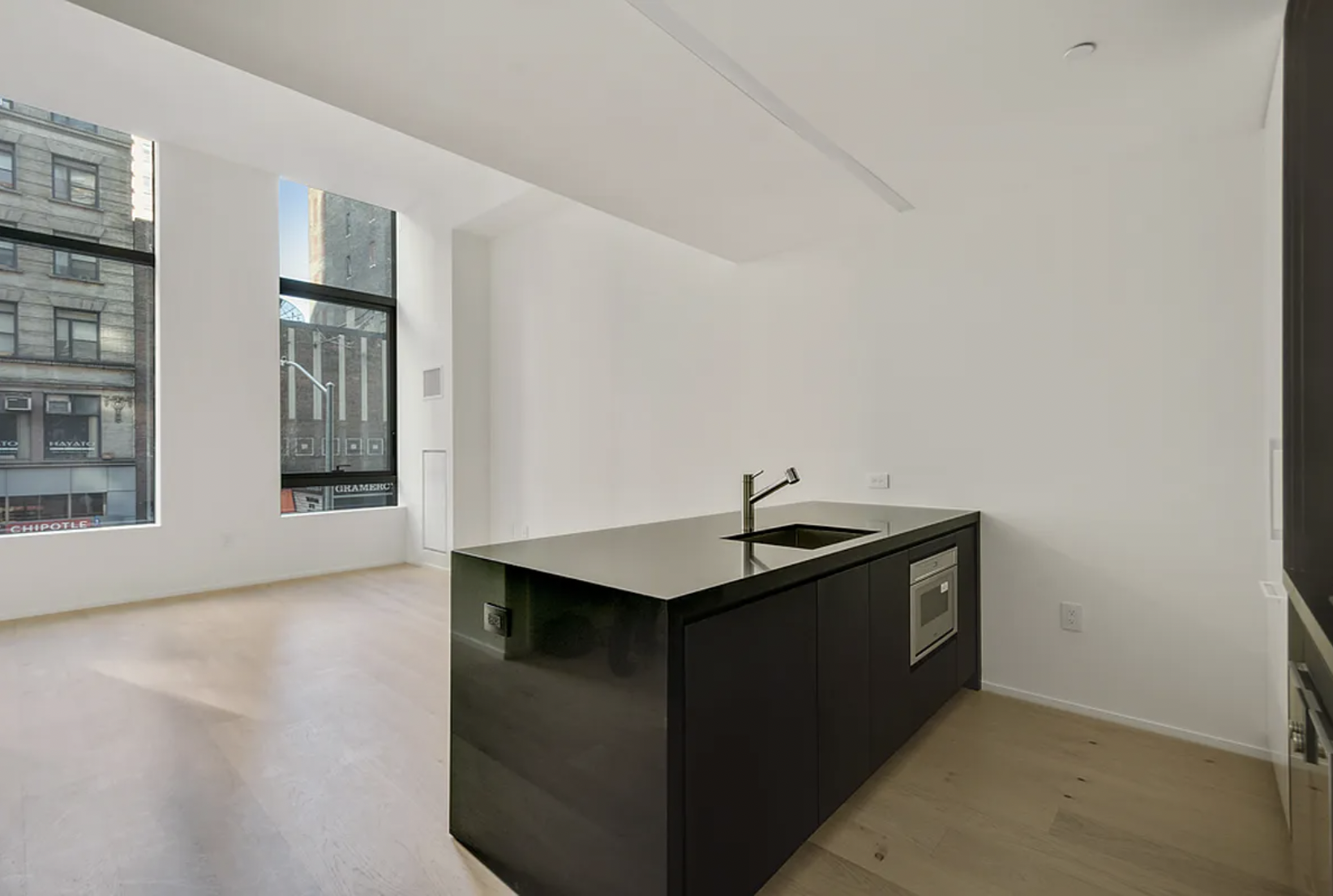 121 East 22nd Street, Unit N203 Manhattan, NY 10010 - Photo 7 of 10 a kitchen with a sink and cabinets