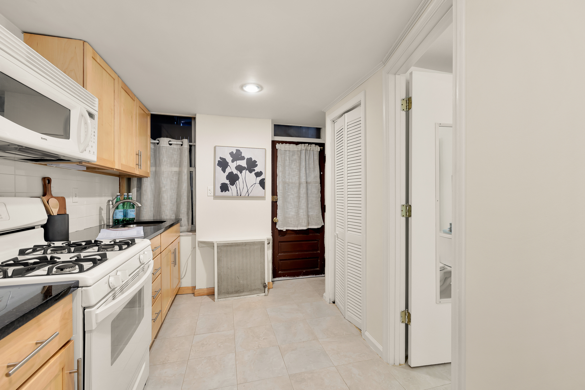 903 F Street Northeast Washington, DC 20002 - Photo 35 of 41 a kitchen with stainless steel appliances a refrigerator and a stove top oven