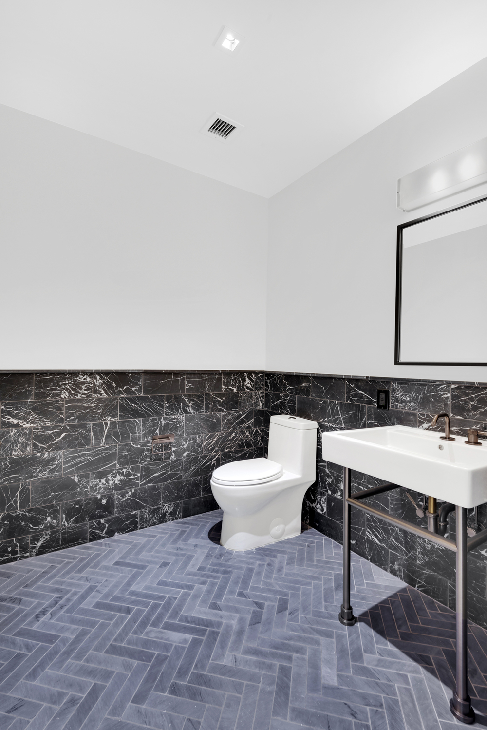 959 1st Avenue, Unit 6P Manhattan, NY 10022 - Photo 11 of 12 a bathroom with a sink toilet and mirror