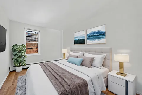 a bedroom with a bed and a window