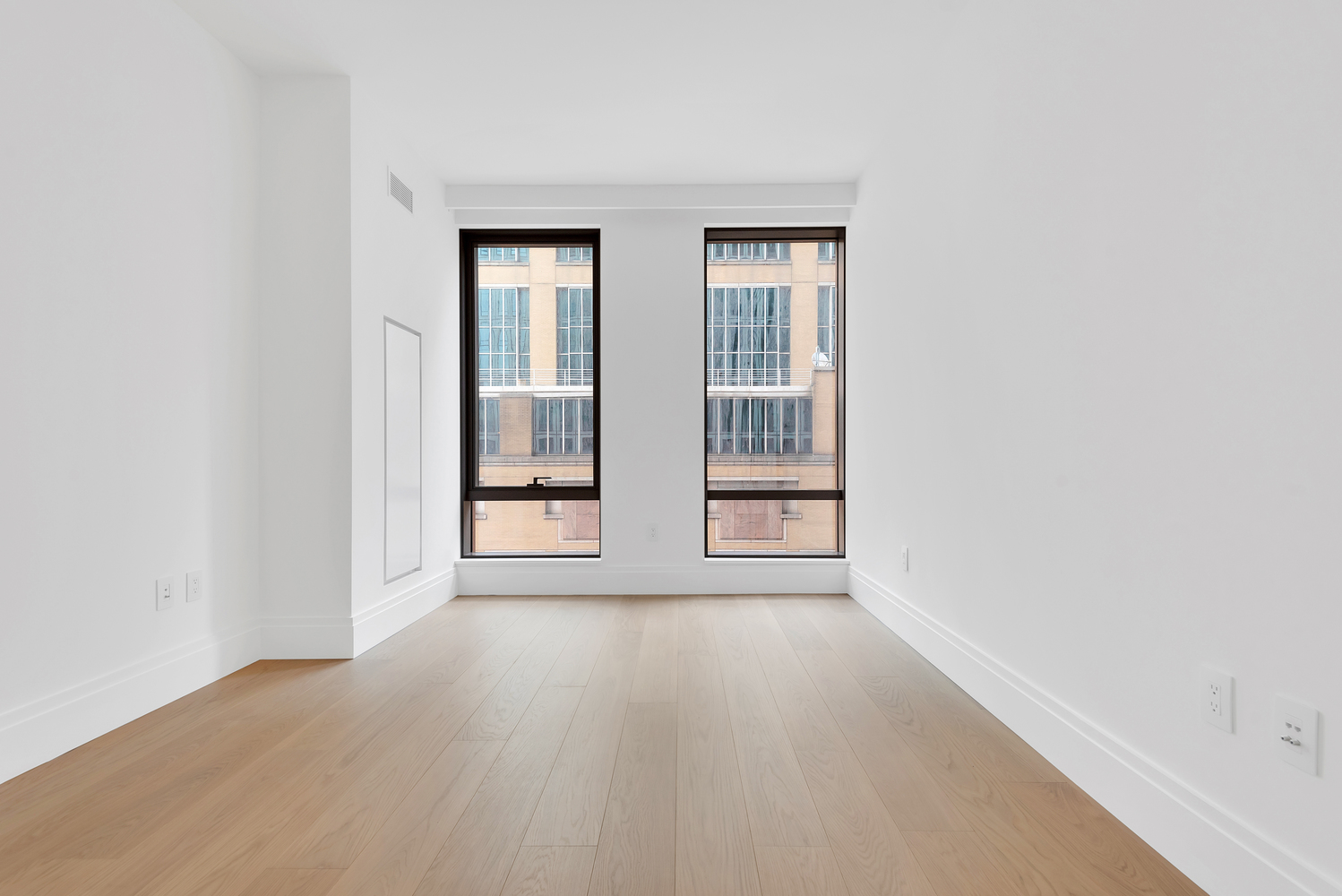 50 West 66th Street, Unit 7B Manhattan, NY 10023 - Photo 15 of 24 an empty room with wooden floor and windows