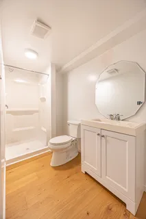 a bathroom with a toilet a sink and mirror