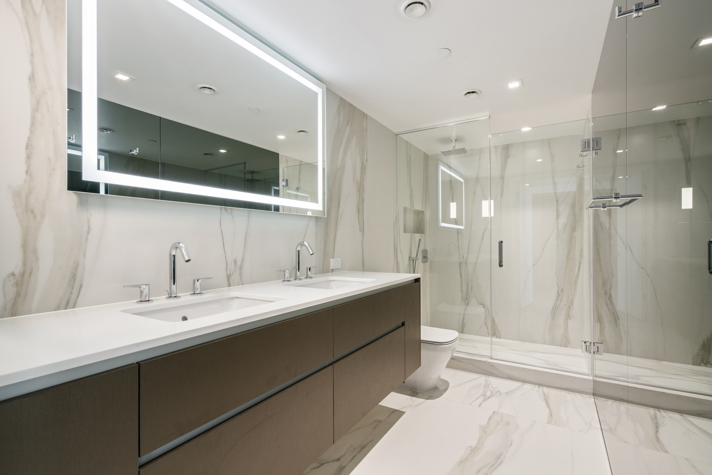 136 West Houston Street, Unit PH Manhattan, NY 10012 - Photo 15 of 26 a bathroom with a double vanity sink mirror and shower