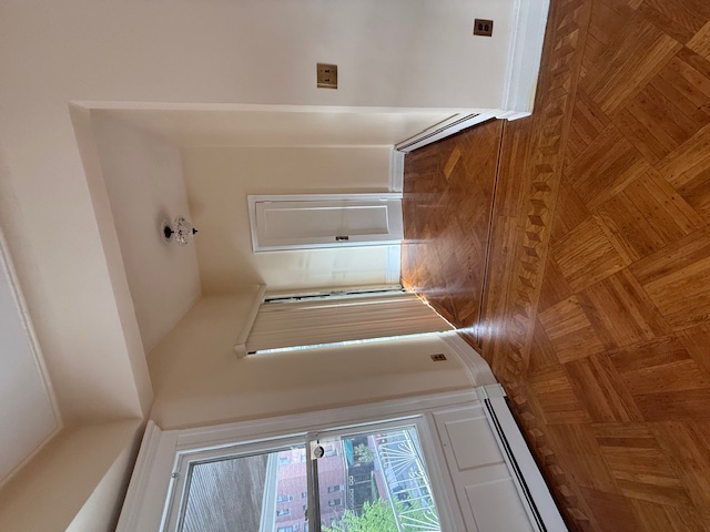 1587 East 18th Street, Unit 2 Brooklyn, NY 11230 - Photo 3 of 13 a view of an empty room with wooden floor and a window