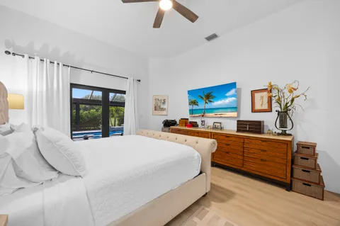 a bedroom with furniture and a flat screen tv