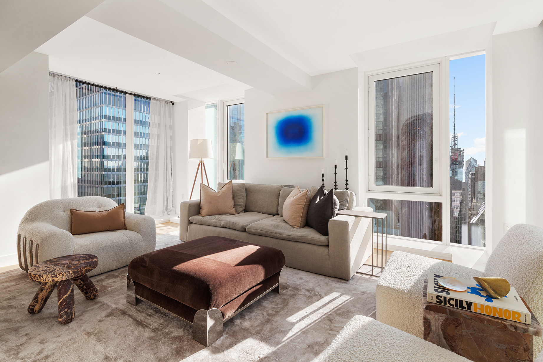 135 West 52nd Street, Unit PH3 Manhattan, NY 10019 - Photo 6 of 17 a living room with furniture and a large window