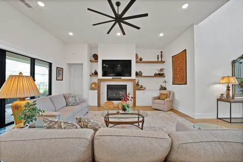 a living room with furniture a fireplace and a flat screen tv