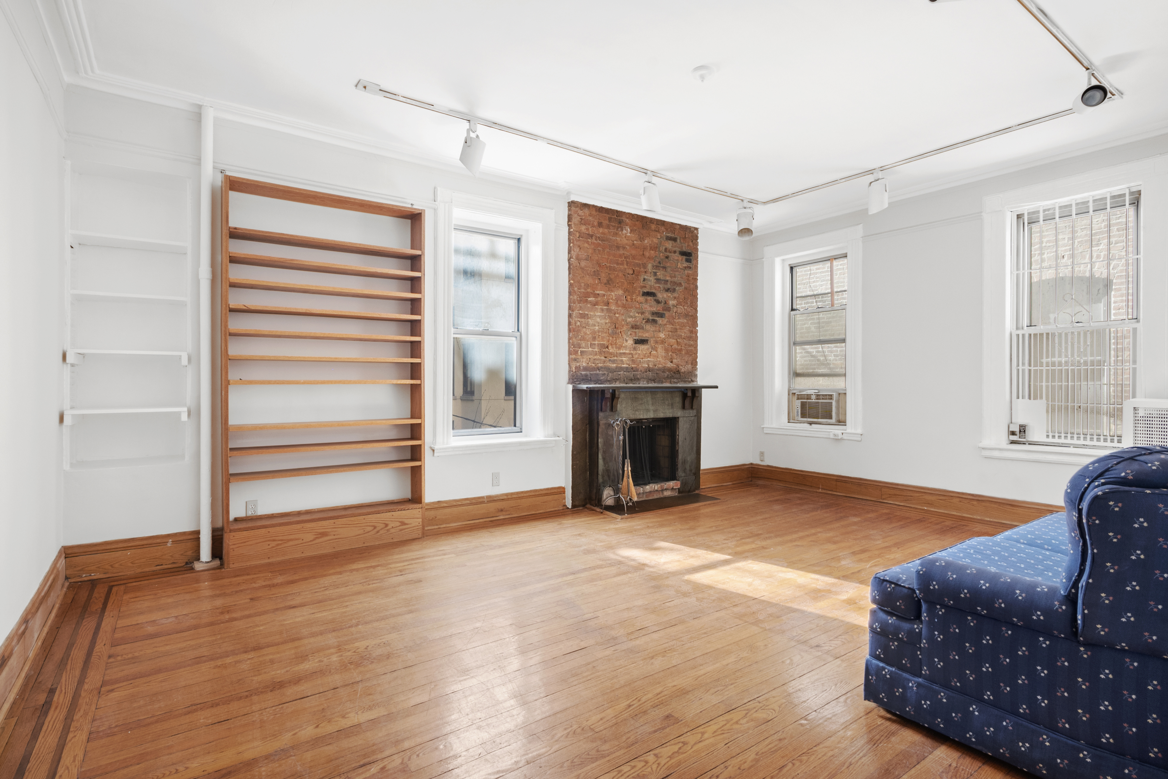 306 West 4th Street, Unit B1B2 Manhattan, NY 10014 - Photo 6 of 9 a living room with furniture and a fireplace