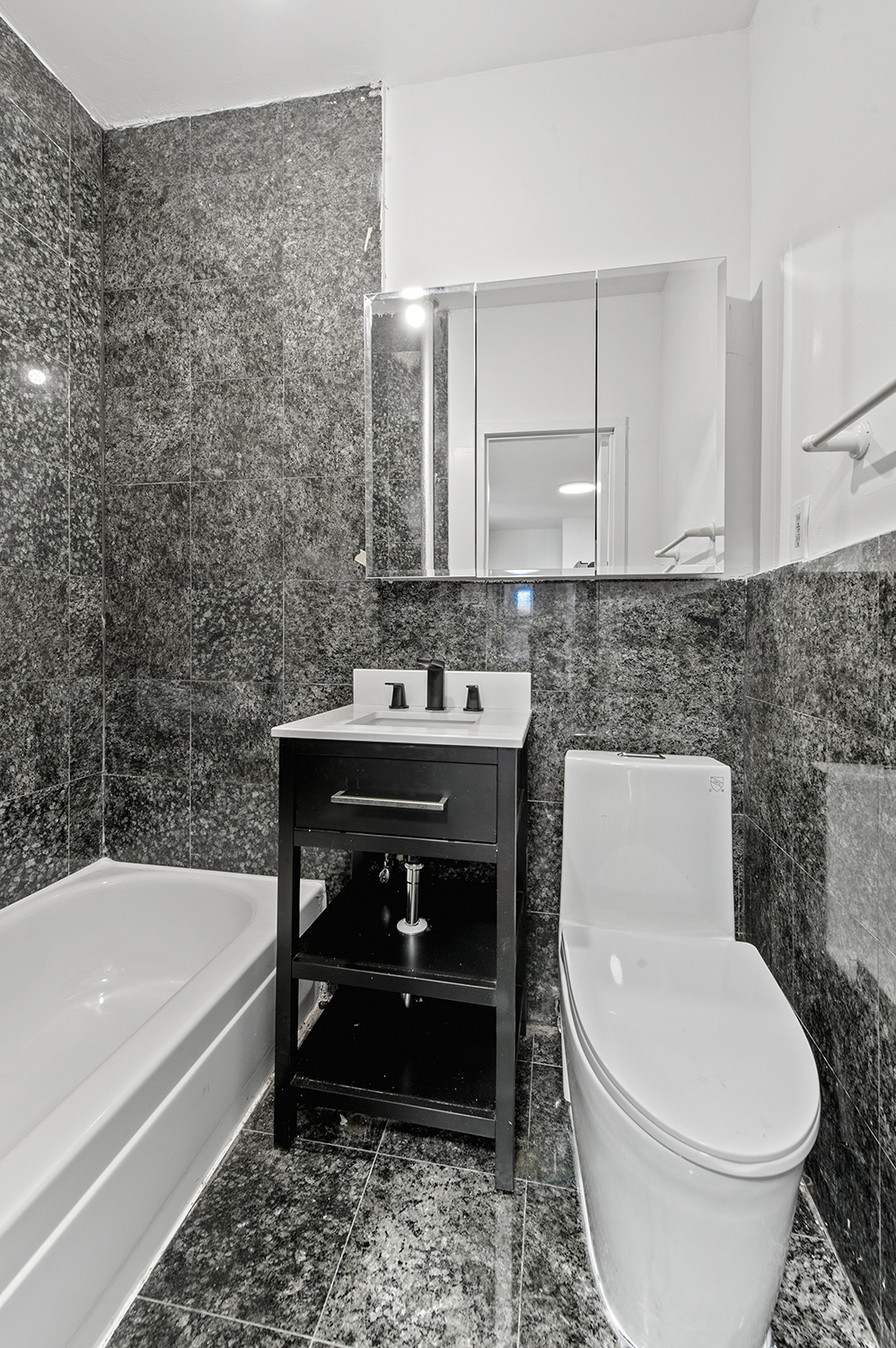 279 East Houston Street, Unit 1C Manhattan, NY 10002 - Photo 4 of 5 a bathroom with a sink toilet and bathtub