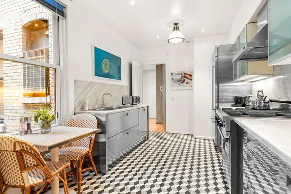 a kitchen that has a sink and a stove in it