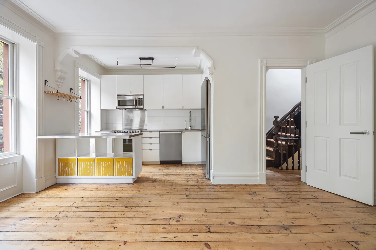 a view of kitchen with furniture and refrigerator