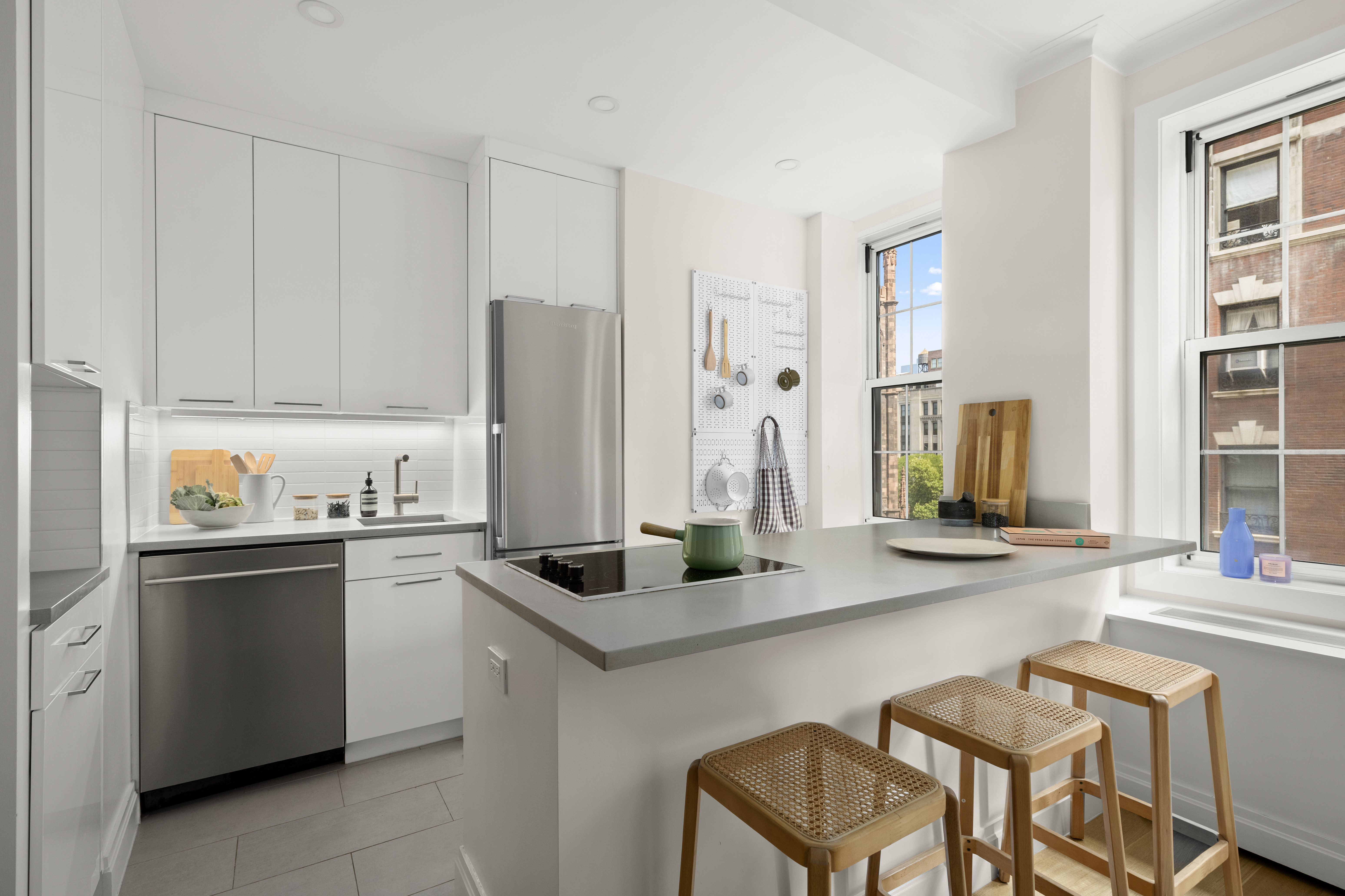 41 5th Avenue, Unit 8CN Manhattan, NY 10003 - Photo 4 of 11 a kitchen with stainless steel appliances granite countertop a stove a sink and a refrigerator