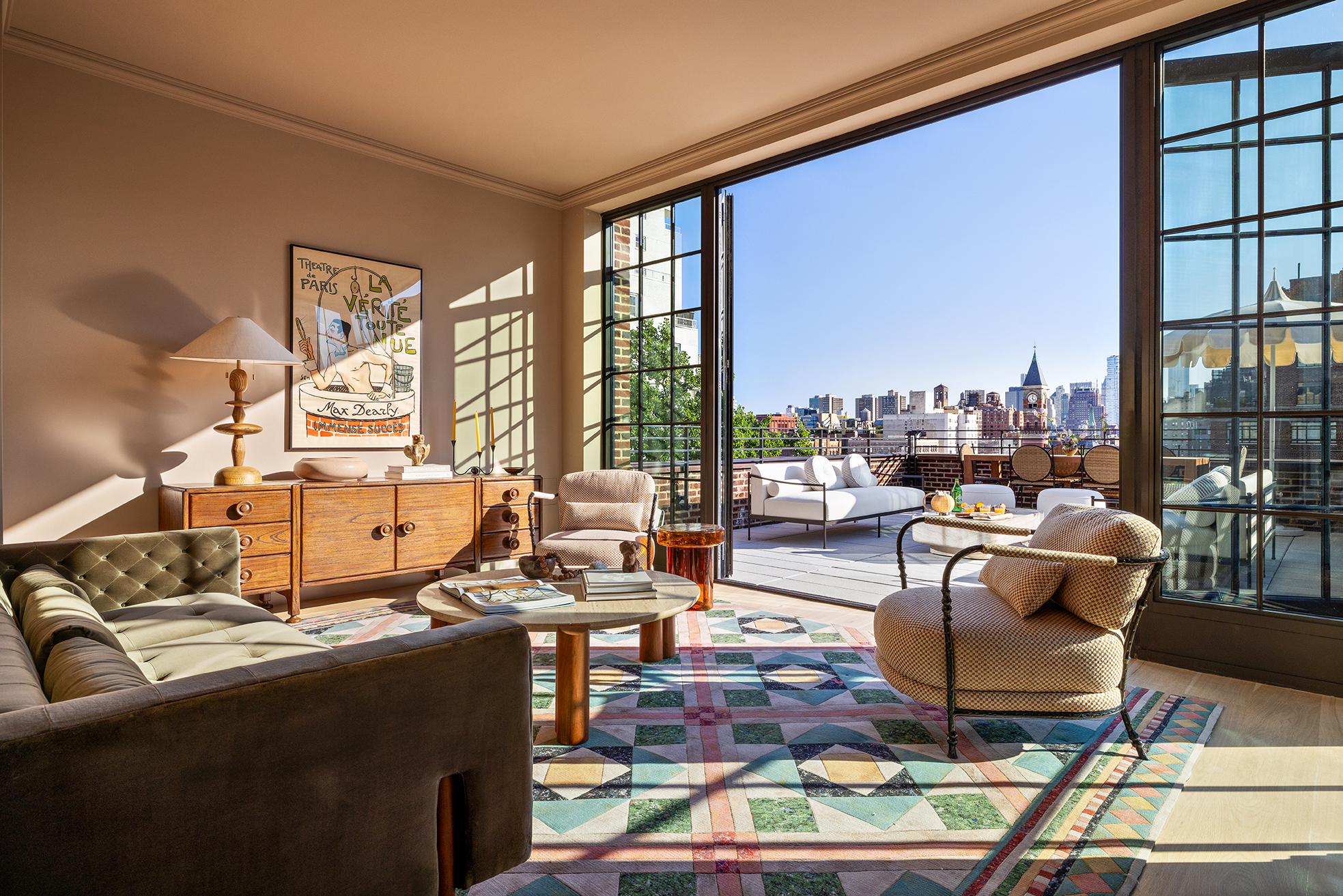 a living room with couches a coffee table and a large window with outer view