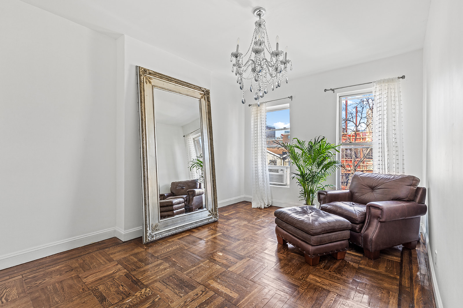 231 Vernon Avenue Brooklyn, NY 11206 - Photo 7 of 13 a living room with furniture and a chandelier