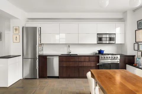 a kitchen with stainless steel appliances granite countertop a refrigerator and a stove top oven