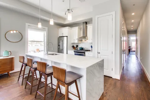 a large kitchen with a table and chairs
