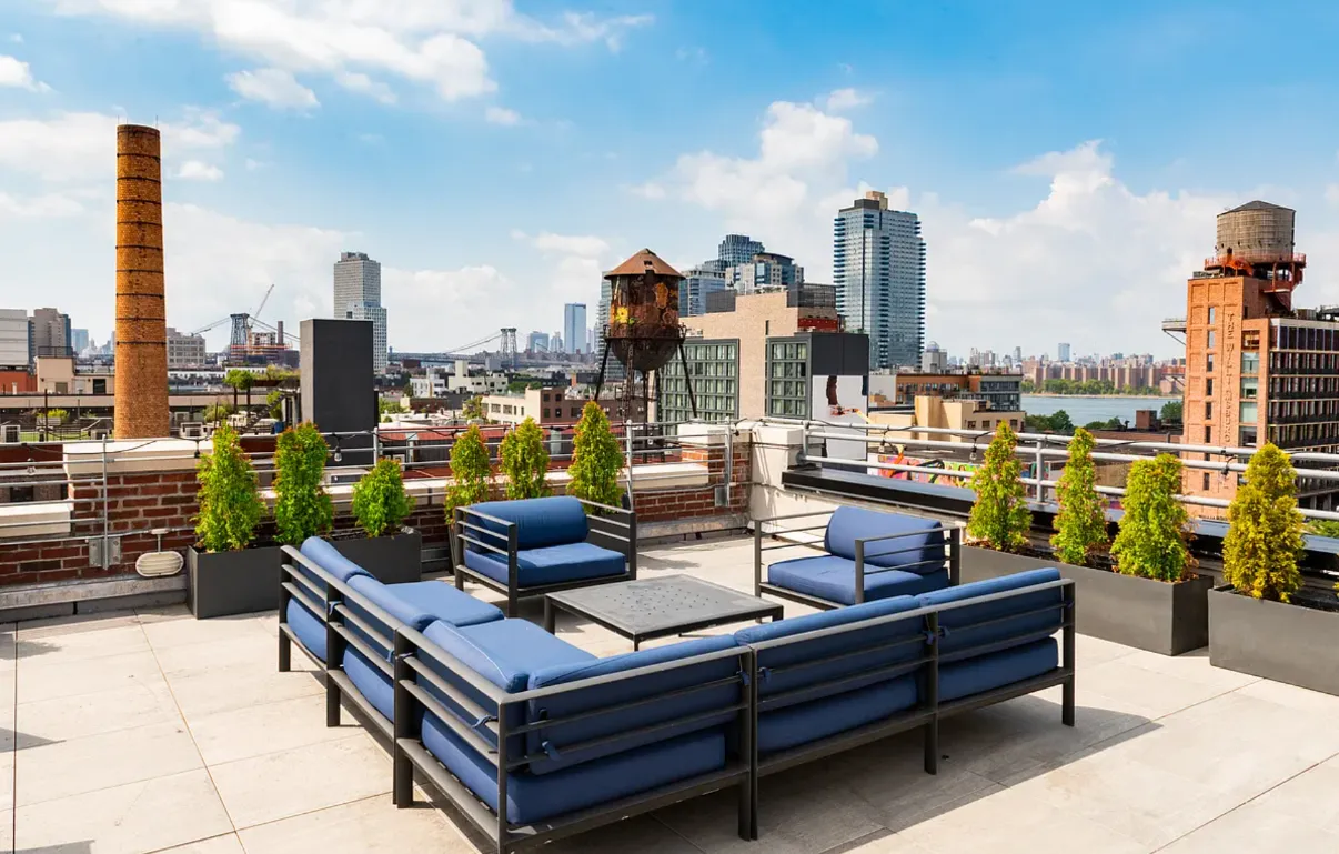 a view of a terrace with lawn chairs