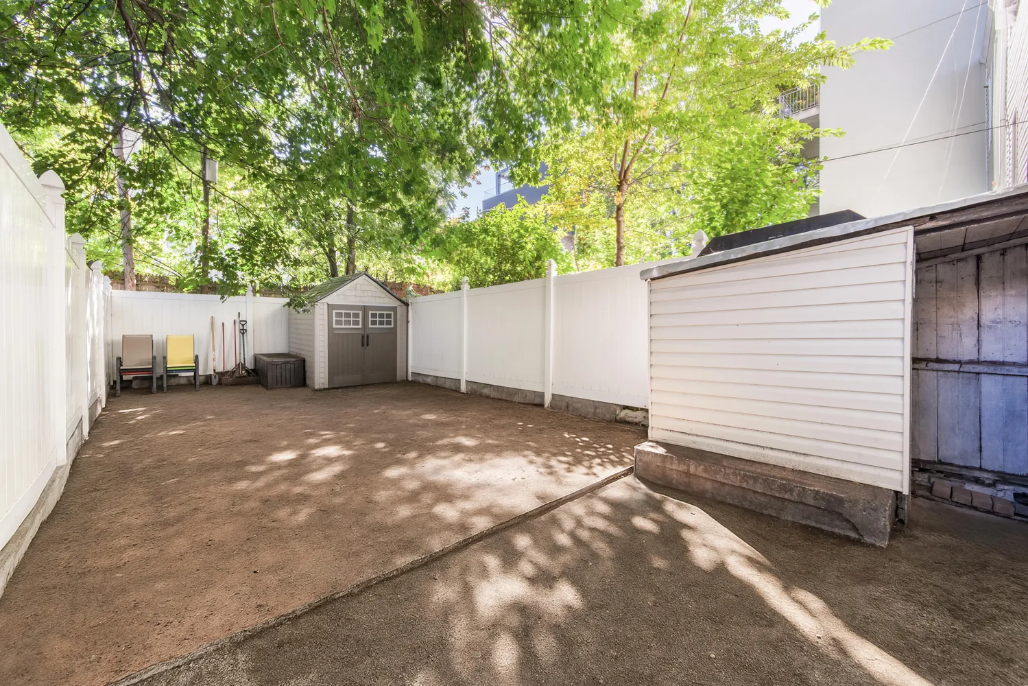 a view of a backyard with a large tree