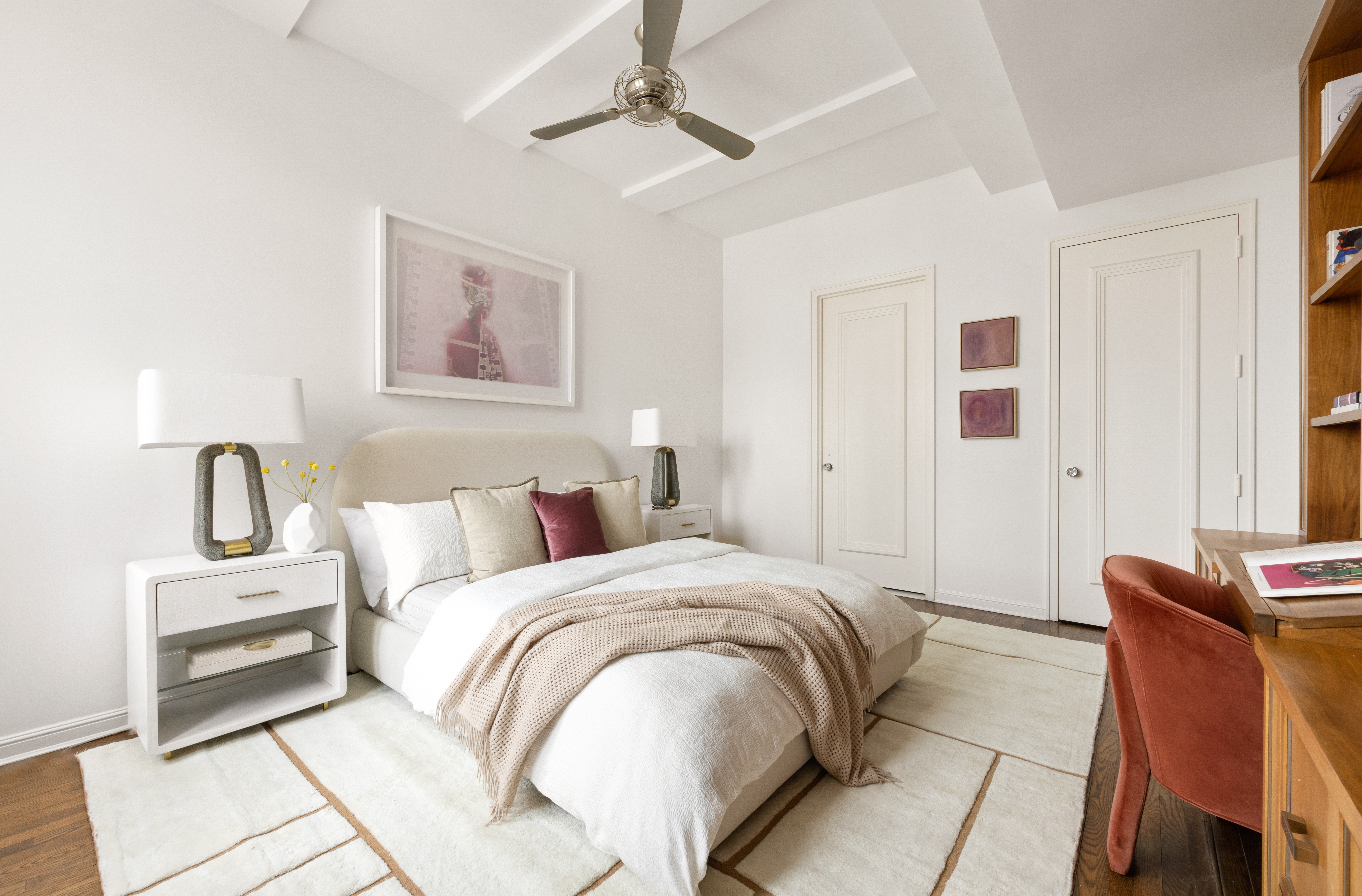 252 7th Avenue, Unit 17I Manhattan, NY 10001 - Photo 12 of 17 a spacious bedroom with a bed a couch and a window