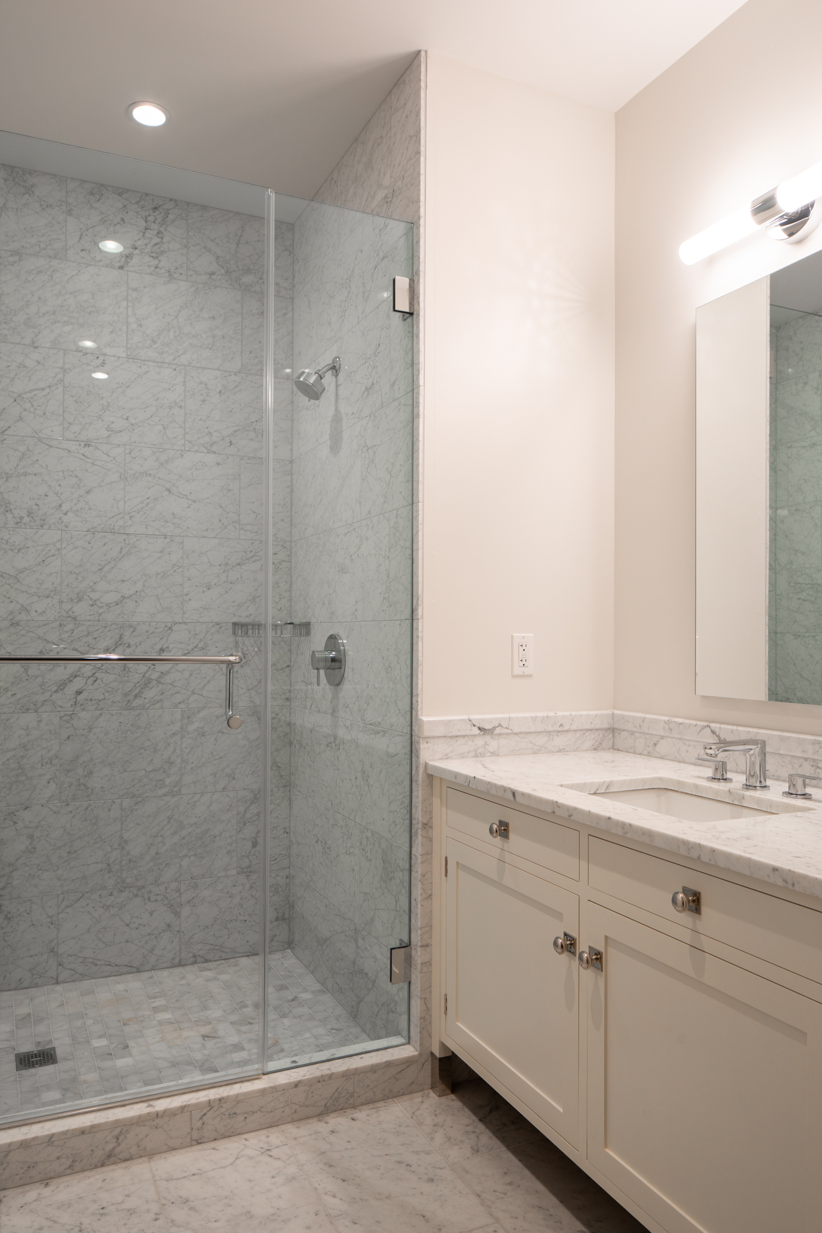 1 Franklin Street, Unit PH2D Boston, MA 02110 - Photo 24 of 26 a bathroom with a shower sink and mirror